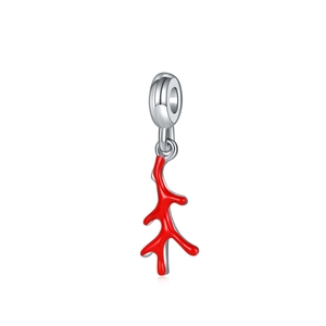 Macro detail of red coral-style charm with silver clasp on white background