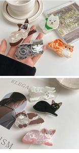 Detailed view of high-quality acetate cat hair claws with pearlescent marble texture