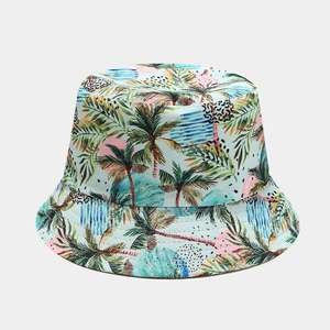 Close-up of tropical flamingo and palm tree print texture on the canvas bucket hat