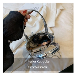 Internal view of silver metallic handbag showing storage space for phone and makeup