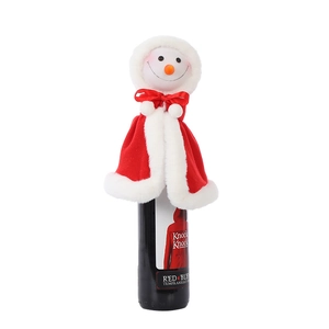 Detailed view of snowman head wine bottle topper with red plush cape and fabric texture