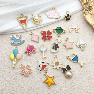 Detailed collection of assorted colorful enamel and gold-plated DIY jewelry pendants