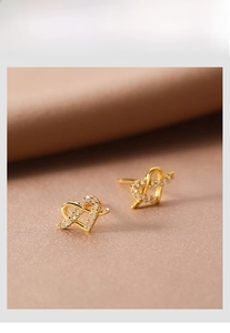 Macro detail of 925 silver heart stud earrings with sparkling pavé cubic zirconia