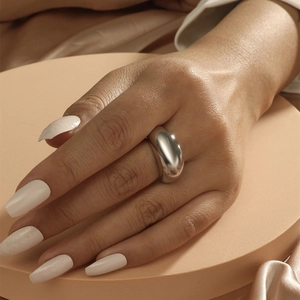 Polished silver dome ring with a minimalist geometric arc design for women