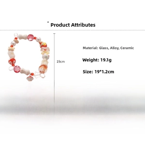 Detail of beaded bracelet with apple charms, glass, alloy and ceramic materials