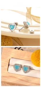Macro view of light blue heart zircon earrings with double screw back titanium steel closure