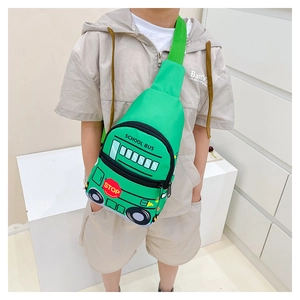 Green school bus chest bag for kids with adjustable strap shown on model outdoors