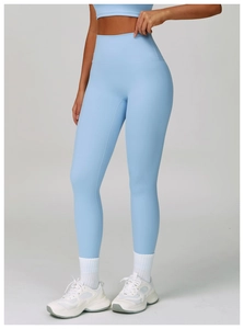 Detail of high waisted compression yoga pants in light blue on a fit model silhouette