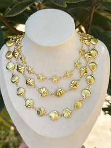 Detailed view of 18k gold plated stainless steel necklace with shell and starfish charms