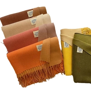 Solid colored cashmere-feel scarves with fringe tassels in various autumn colors