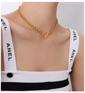 Detail of 18K gold-plated chunky link chain necklace with a stylish OT toggle clasp