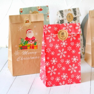 Christmas kraft paper gift bags with stickers featuring Santa, snowflake, and tree patterns