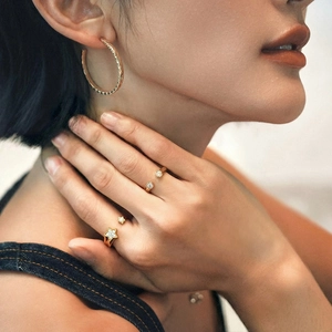 Gold plated star open ring with sparkling cubic zirconia on female model hand