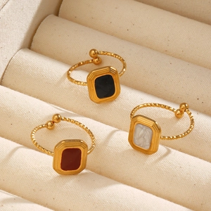 Minimalist square geometric rings with colorful enamel finishes in a jewelry box