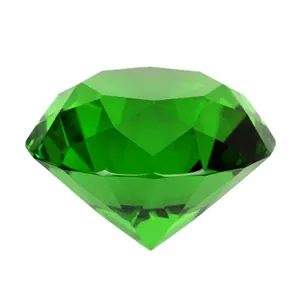 Bright green large acrylic crystal diamond toy stone with faceted cut on white background