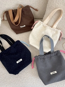 Woolen polka dot drawstring handbags in navy, brown, grey and beige colors