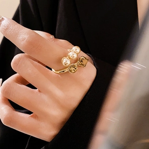 French vintage open ring with white pearls and amber zircon stones on model's hand
