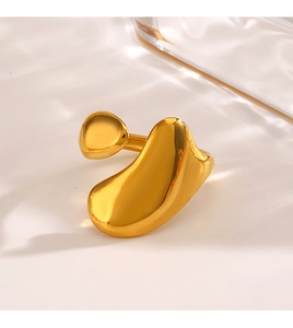 Detailed macro view of the golden liquid-style irregular open ring on a clean surface