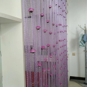 Detail of purple string curtain featuring decorative pink roses for interior partitions