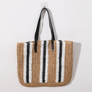 Striped woven straw tote bag with black leather handles for beach or casual use