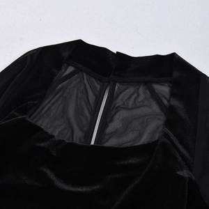 Detail of elegant velvet and mesh patchwork stitching on the black long sleeve dress
