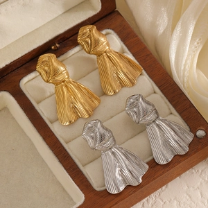 Vintage 18k gold and silver bow knot stud earrings in a wooden jewelry box display