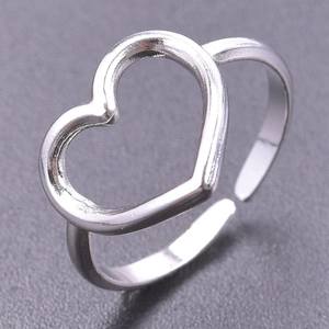Detailed macro shot of an adjustable silver open ring with a hollow heart-shaped frame