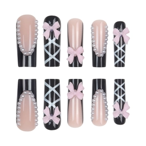 Press-on nail set with black and pink French design featuring pearls and 3D bows