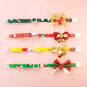 Detail of Christmas pet collars with festive patterns, bow knots and golden bells