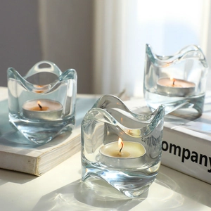 Three-piece set of wavy transparent glass candle holders with tealights for table decor
