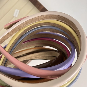 Detail showing various glossy headbands with a non-slip velvet lining interior
