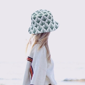 Close-up of geometric leaf pattern bucket hat with reversible fabric for beach wear