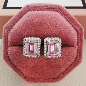 Macro shot of emerald cut pink zircon earrings in a velvet octagon jewelry box