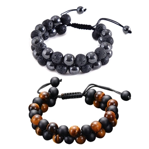 Detail of adjustable double-layer beaded bracelets with tiger eye and lava stone textures