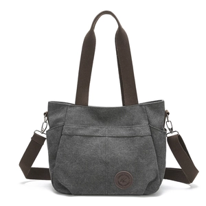 Grey canvas tote bag with brown straps and multi-pocket design on a white background
