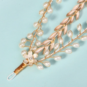 Elegant gold handmade bridal headband with white pearls and golden leaves on blue background