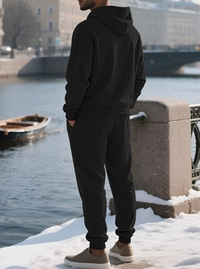 Detail of black hooded sweatshirt suit with jacquard texture in winter outdoor river setting