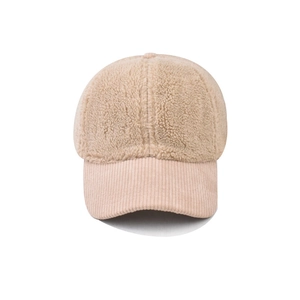Detail of sherpa fleece baseball cap with corduroy brim in soft beige texture