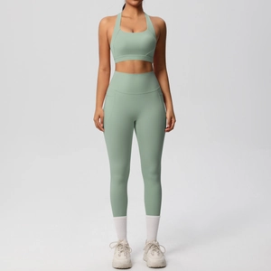 Detail view of sage green yoga set showing racerback sports bra and high-waist pocket leggings