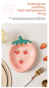 Detail of strawberry shaped ceramic plate with hand painted glaze and star patterns