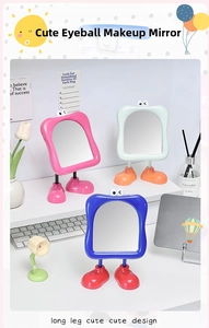 Detail of cute vanity mirror with big eyes and long leg base in pastel colors