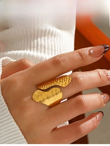 Detail of 18K gold plated wide ring featuring textured stipple and hammered finish