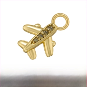 Detailed view of a gold airplane pendant with olive green zircons and 10.5x14mm dimensions