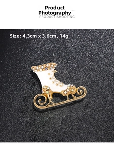Detail of ice skate brooch with white enamel, gold plating and crystals, size 4.3x3.6cm