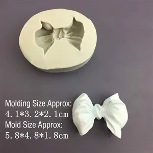 Silicone bow tie mold for DIY fondant and resin with a finished white sample shown