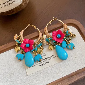 Bohemian woven earrings with pink flowers, turquoise drops, and elephant charms