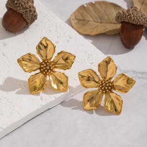 Elegant gold flower stud earrings in stainless steel on a natural stone background