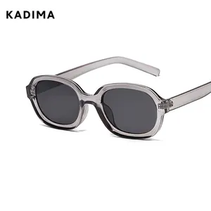 Oval translucent grey sunglasses with dark grey lenses and retro concave frame
