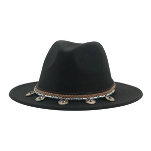 Detail of bohemian style hat band with turquoise beads and metal pendants on black wool fedora