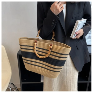 Close-up of natural woven tote bag featuring retro bamboo handles and blue striped texture